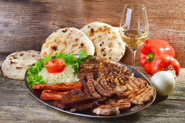 Wholesome platter of mixed meats including grilled steak. Balkan food