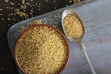 Deurstickers healthy uncooked millet grains © neillangan