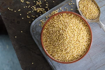 Foto op Canvas healthy uncooked millet grains © neillangan