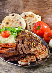 Wholesome platter of mixed meats including grilled steak. Balkan food