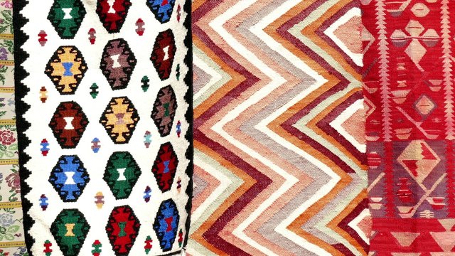 Hand made rug swinging and moving in the wind. Colorful surface, texture of traditional woolen and vintage hand made rug.