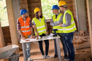 Architects discussing about blue print