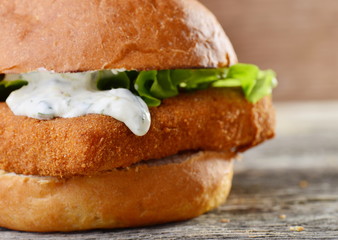 Fresh and fried fish burger with vegetables