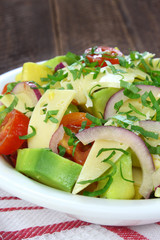 Salad with avocado, cheese, tomato and red onion