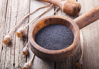 Poppy seeds,vintage wooden mortar.selective focus.