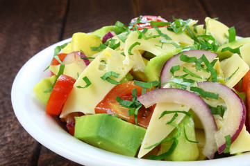 Salad with avocado, cheese, tomato and red onion