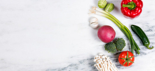 Fototapeta na wymiar Fresh whole vegetables and fruit on natural white marble 
