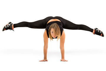 Young woman doing standing split isolated