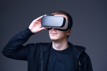 Young man using Virtual Reality glasses