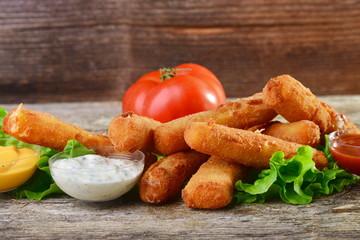 Delicious breaded mozzarella cheese sticks with dipping sauces.