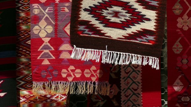 Hand made rug swinging and moving in the wind. Colorful surface, texture of traditional woolen and vintage hand made rug.