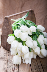 A bouquet of white tulips in an old box.Flowers of spring and love.Vintage style.Happy Mothers Day.selective focus.