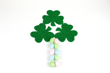 decoration of green clover leaves and colorful eggs