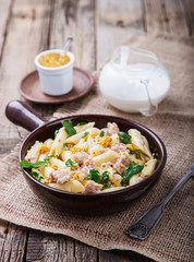 Pasta with meat , herbs and cream with a sauce of grain mustard.