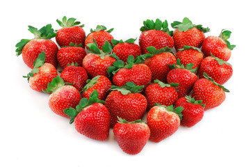 strawberries arranged in heart shape on white background