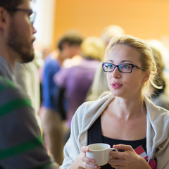 Peoplegathering and socializing during coffee break at conference meeting.  Business and...