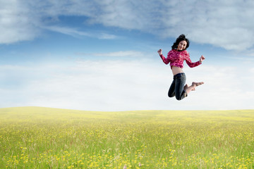Asian woman leaps in the nature