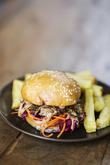 pulled pork and pickled vegetables sandwich with french fries