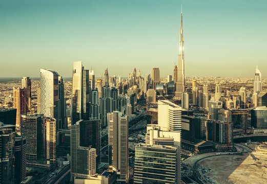 Beautiful architectural background. Panorama view of Dubai's business bay towers at sunset.