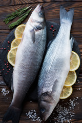 Raw seabass with lemon and seasonings ready to be cooked