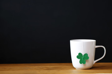 Green clover with white mug