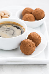 chocolate truffles and a cup of coffee, vertical