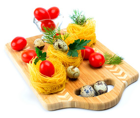 Pasta nests with cherry tomatoes and quail eggs.