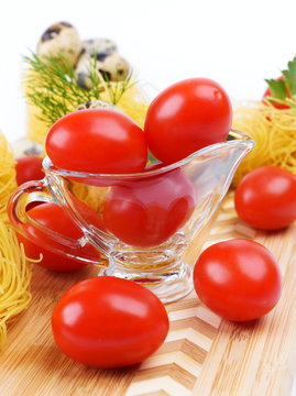 Glass Gravy boat with cherry tomatoes.