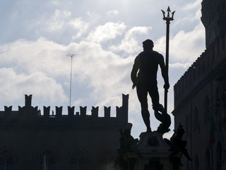 sculpture of Neptune in shadow side  in Bologna in Italy