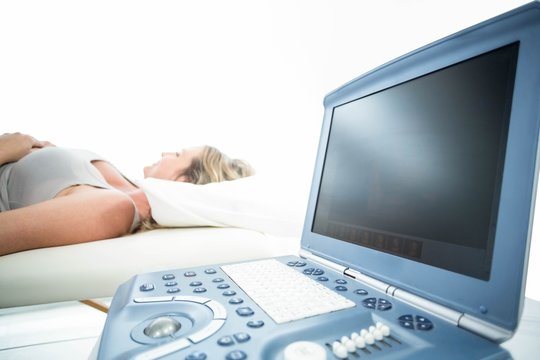 Pregnant woman receiving ultrasound treatment