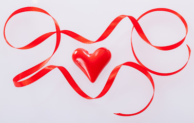 Twisted red ribbon and ceramic heart
