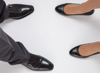 Closeup of businessman's and businesswoman's legs
