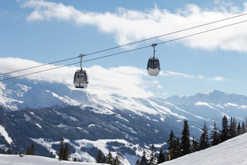 Winter mountains landscape with cable car and  beautiful, sunny sky
