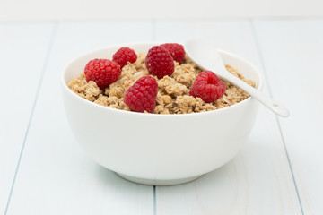 Granola in a bowl with raspberries, muesli