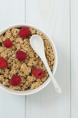 Granola in a bowl with raspberries, muesli