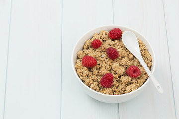 Granola in a bowl with raspberries, muesli