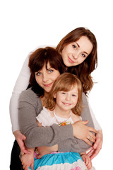 Mother hugging with two daughters.