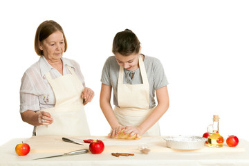 the grandmother and the granddaughter knead dough