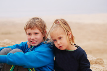 Portrait of 5 years girl with her autistic 8 years old brother o