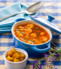 Seafood soup in a small blue cooking pot