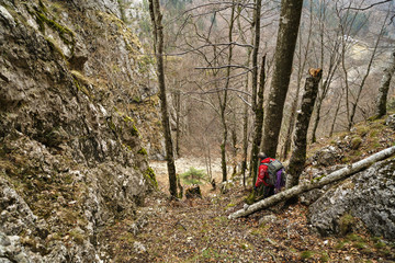 Caucasian man with backpack hiking into the mountains