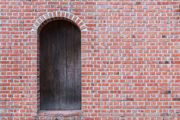 Old brick wall with wooden door.