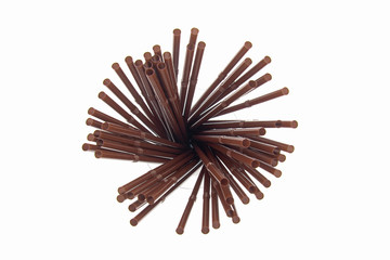 Brown plastic straws on white background