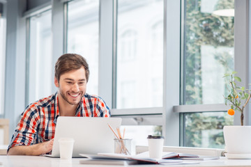 Pleasant man working on the computer 