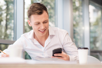 Pleasant man holding cell phone 