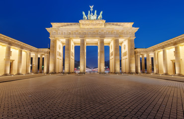 The famous Brandenburger Tor in Berlin is illuminated at night © elxeneize