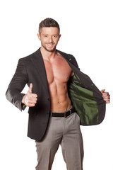 smiling shirtless muscular man in a jacket and pants showing thumbs up