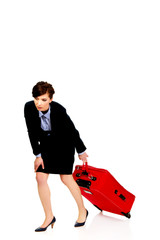 Tired businesswoman with suitcase.