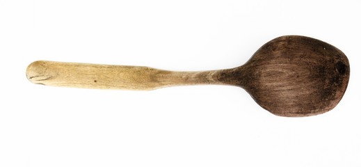 Used self-made wooden spoon isolated. Close-up top view of wooden spoon isolated over white. Wooden spoon on isolated background. Wooden spoon with long handle