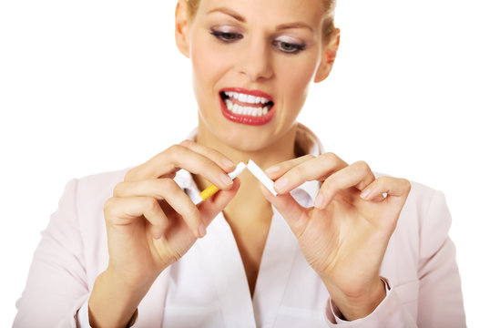 Smile business woman breaking a cigarette